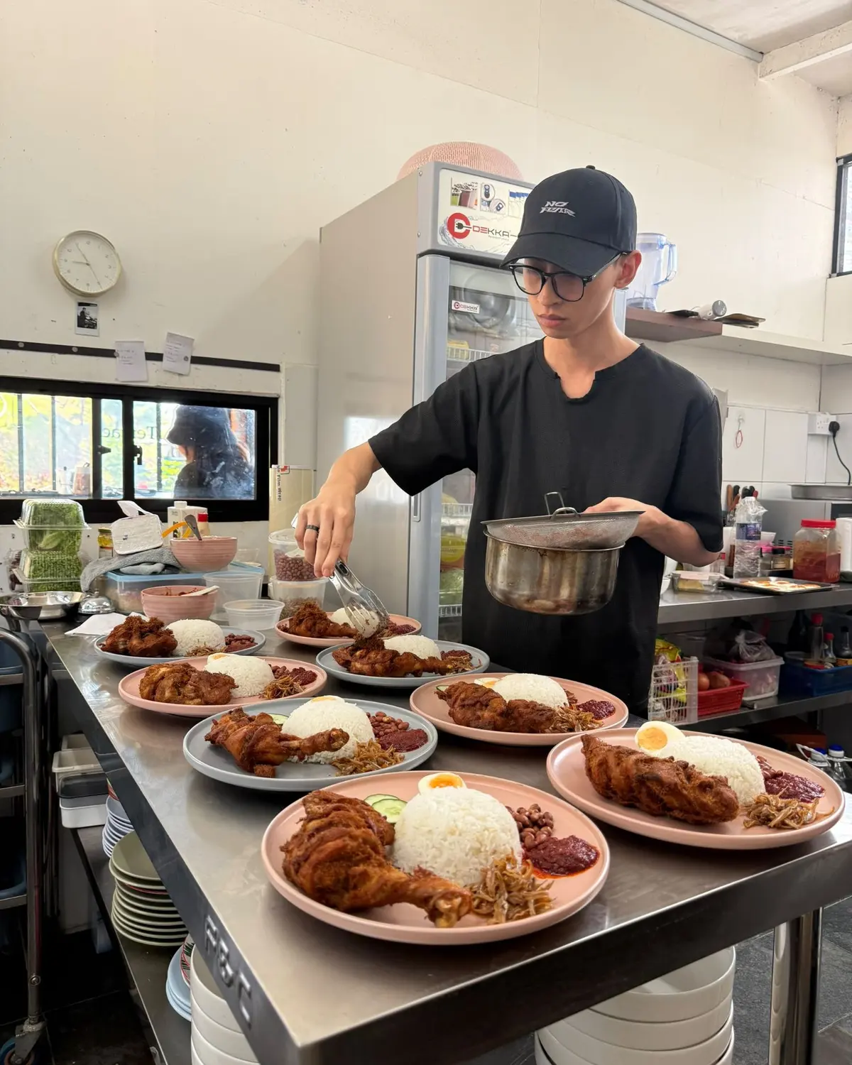 Our kitchen plating nasi lemak with fried chicken for a group